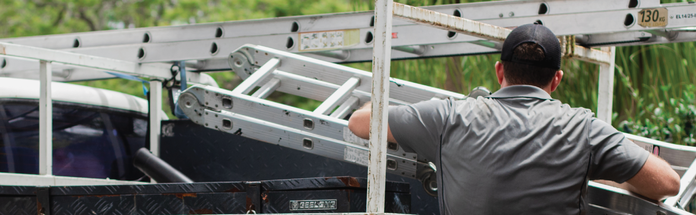 SL_FebCampaignStills_KS_7 picture of man loading a truck with ladder and white writings "carry the essentials"