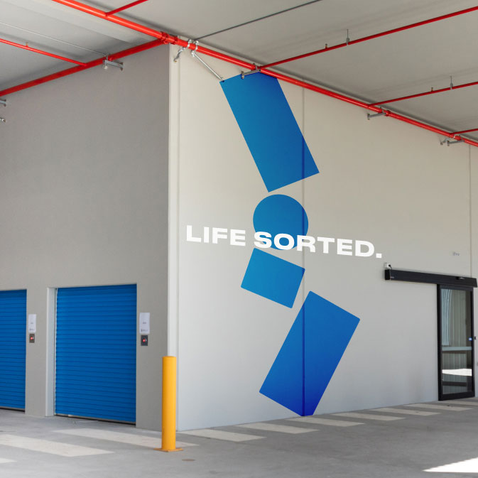 http://A%20storage%20facility%20with%20blue%20doors%20and%20a%20sign%20that%20says%20life%20sorted.