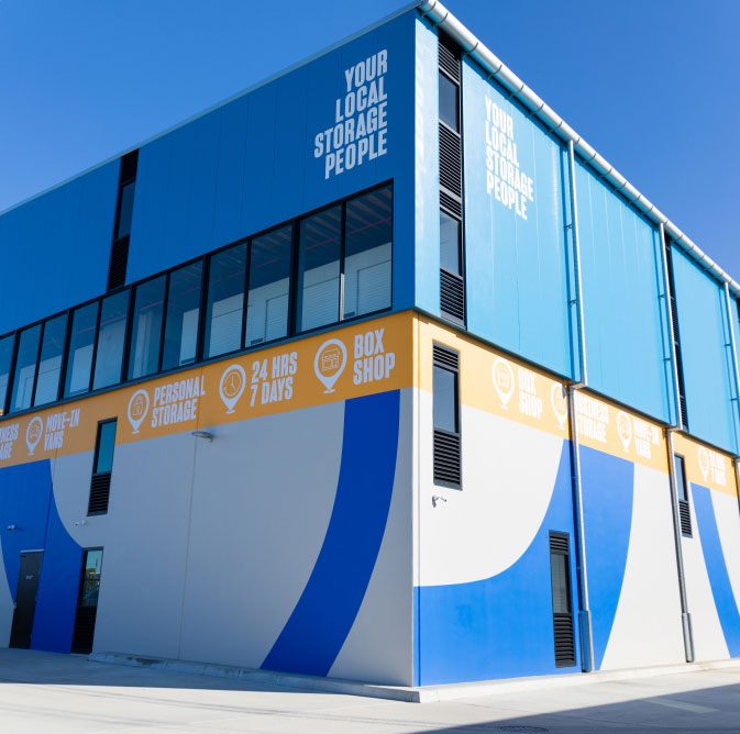 http://A%20blue%20and%20yellow%20building%20with%20a%20sign%20on%20it.