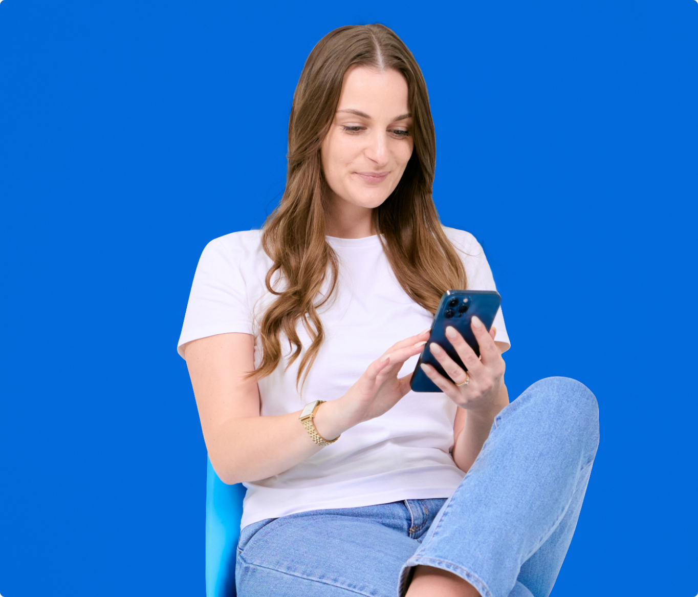 form-img A woman sitting on a blue chair using a cell phone.