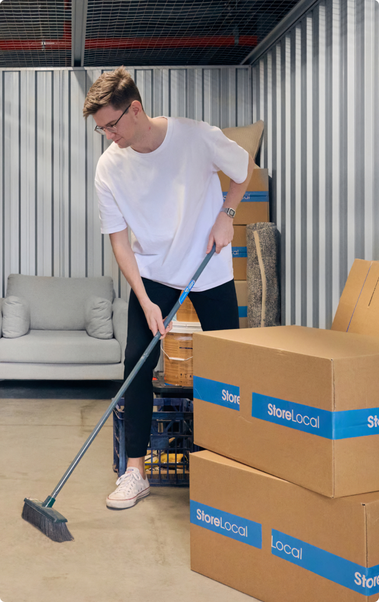 usp-img A man cleaning boxes in a storage unit.
