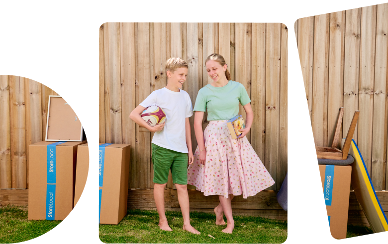 Hero Image mobile Two children standing in front of a wooden fence with boxes in front of them.