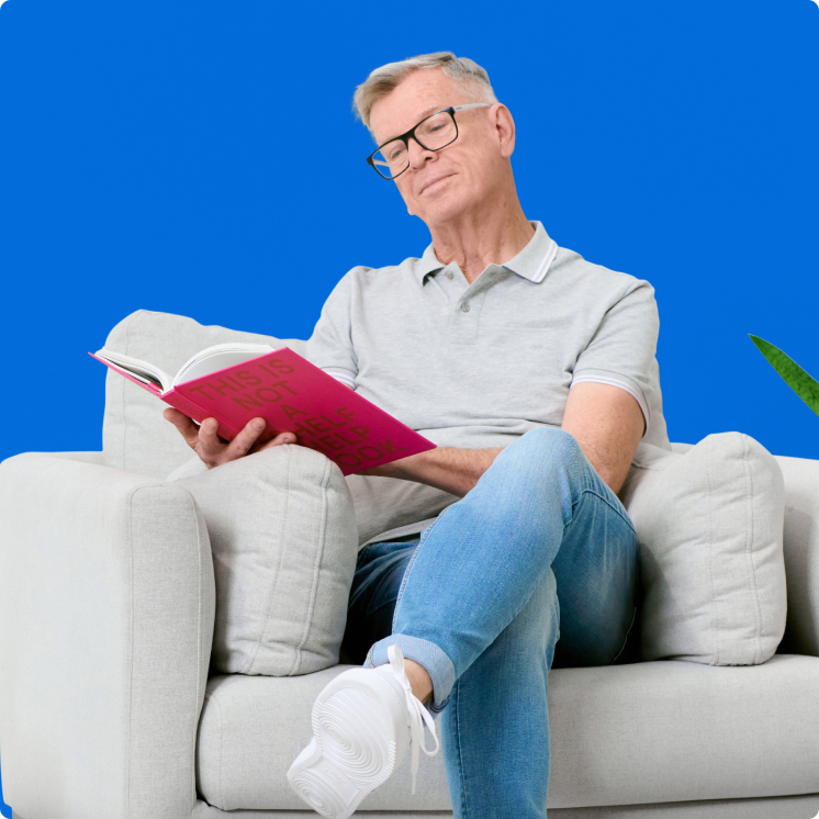 office-appraisal-img A man sitting in a chair reading a book.