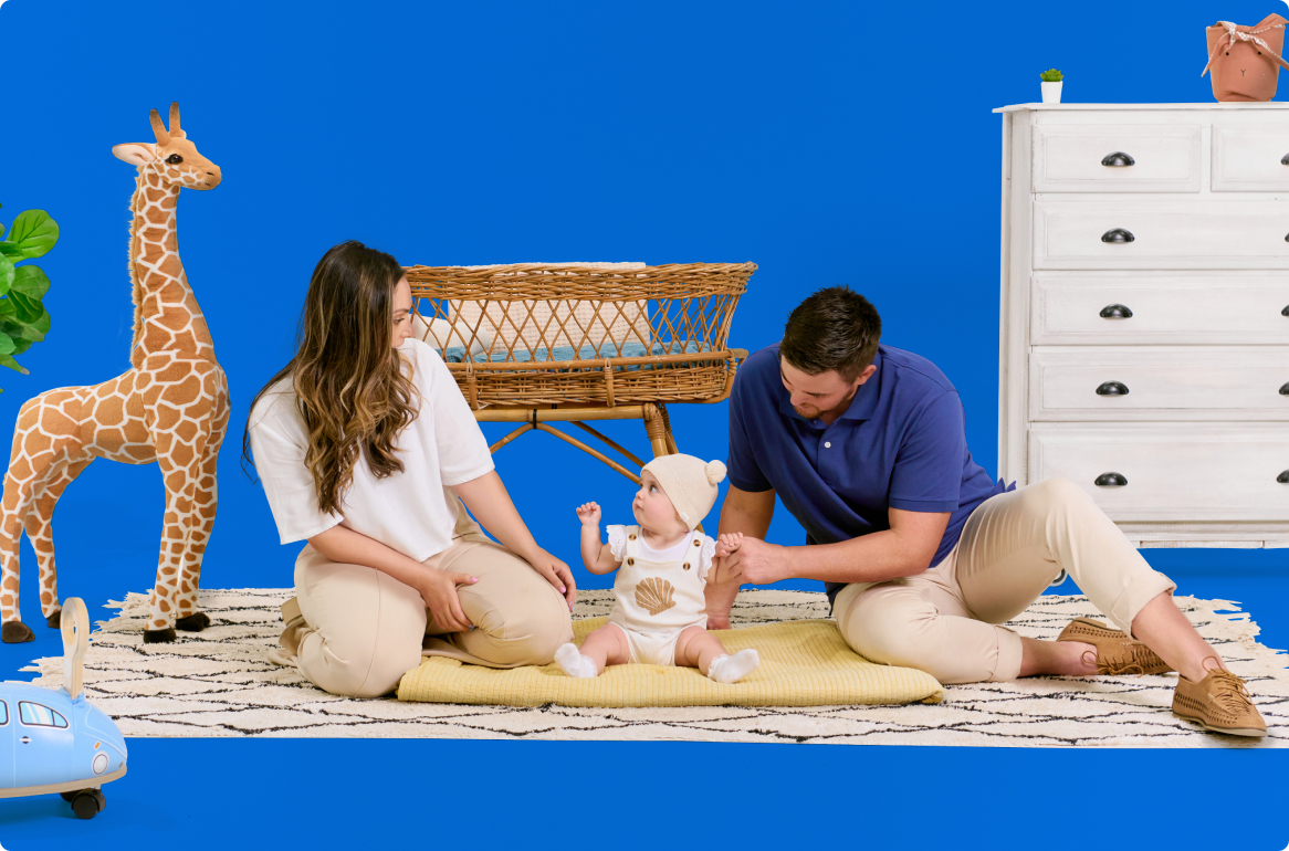personal-storage-img1 A family is sitting on a rug with a baby and a giraffe.