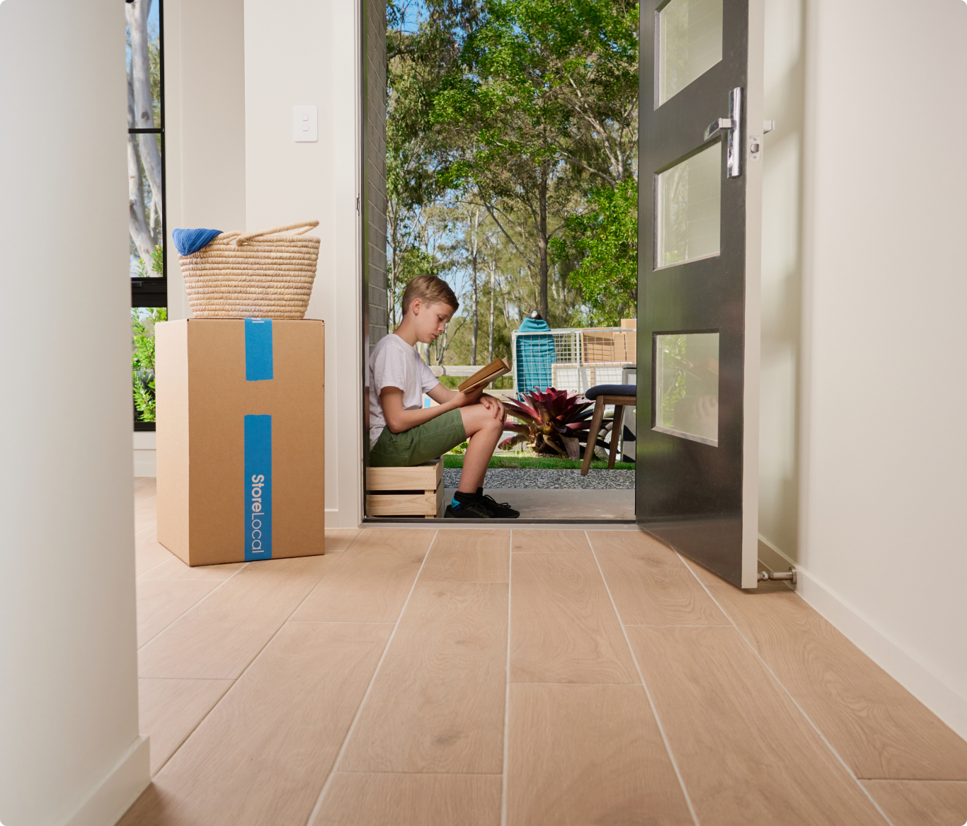 storage-type-img1 A boy sitting on the floor in front of a door.