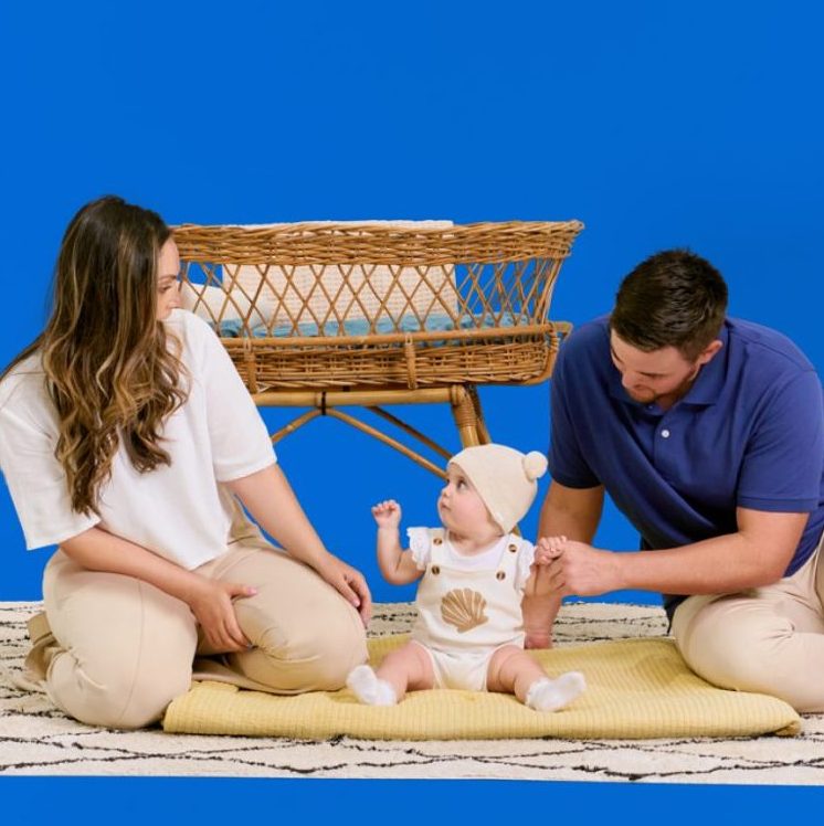 50%-off-6-months-banner-bg A man and woman sitting on a rug with a giraffe.